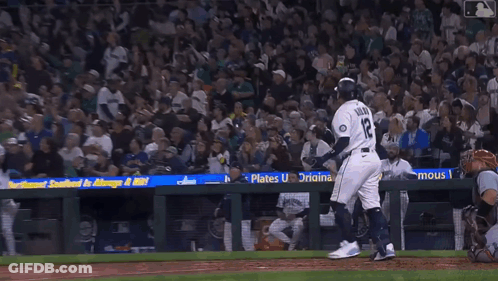 Two Mariners Baseball Players Are Standing Next To Each Other On The Field GIF