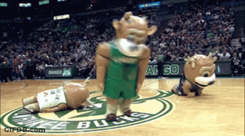 Two Mascots On A Basketball Court With The Word Bucks On The Floor GIF