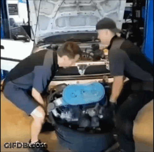 Two Mechanics Working On Car Engine In Garage GIF
