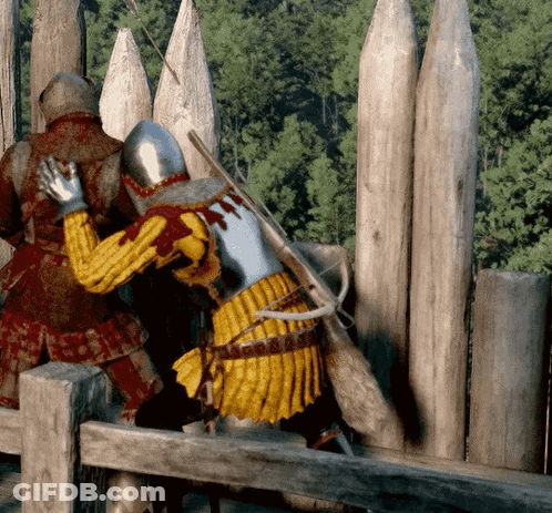Two Medieval Soldiers Standing By Wooden Fence GIF
