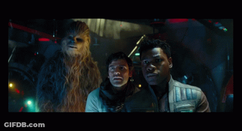 Two Men And A Chewbacca Are Standing In A Dark Room GIF
