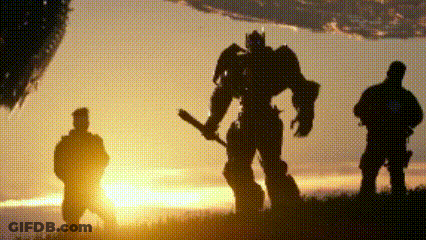 Two Men And A Robot Holding A Bat At Sunset GIF