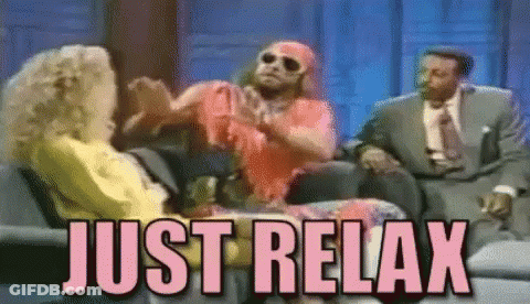 Two Men And A Woman Are Sitting On A Couch With The Words Just Relax Above Them . GIF