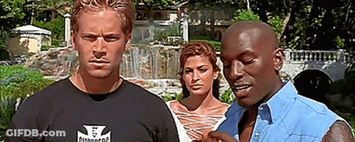 Two Men And A Woman Are Standing Next To Each Other In A Park . GIF