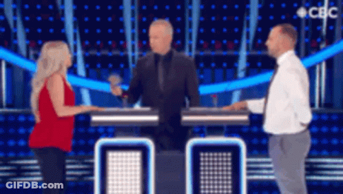 Two Men And A Woman Are Standing On A Stage In Front Of A Sign That Says Cdc GIF