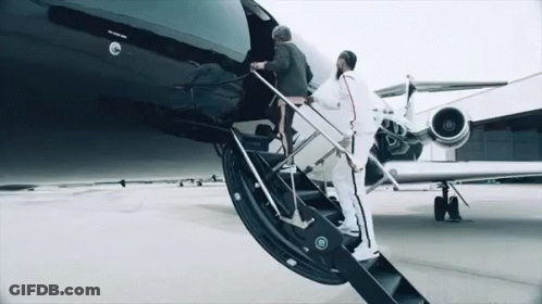 Two Men Are Boarding A Private Jet With The Word Jet On The Side Of It GIF