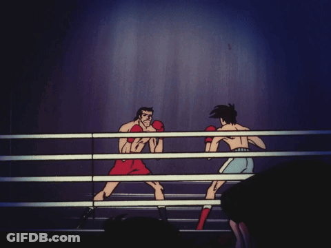 Two Men Are Boxing In A Ring And One Is Wearing Red Gloves GIF