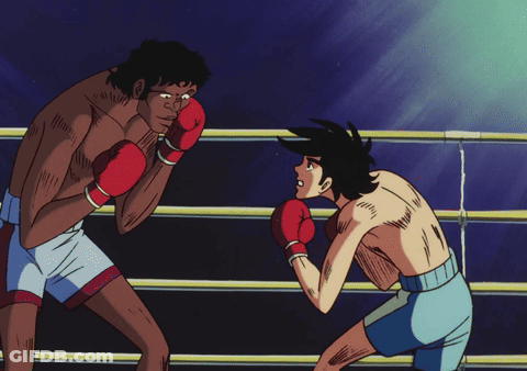 Two Men Are Boxing In A Ring And One Of Them Is Wearing Red Boxing Gloves GIF