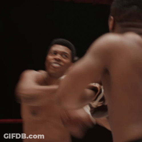 Two Men Are Boxing In A Ring Without Shirts GIF