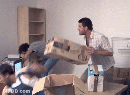 Two Men Are Carrying A Large Cardboard Box That Says ' Dhl ' On It GIF