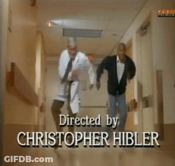 Two Men Are Dancing In A Hallway With A Sign On The Wall That Says Family GIF
