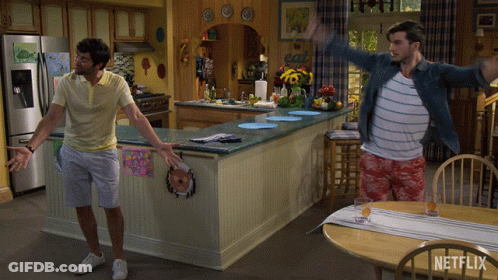 Two Men Are Dancing In A Kitchen With A Sign That Says Eat GIF