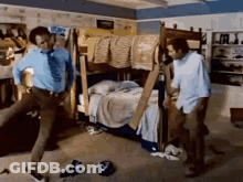 Two Men Are Dancing In A Room With A Bunk Bed In The Background GIF