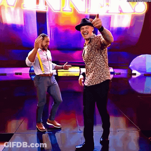 Two Men Are Dancing In Front Of A Sign That Says ' Winner ' GIF