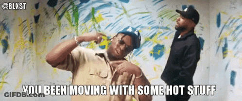 Two Men Are Dancing In Front Of A Wall With The Words You Been Moving With Some Hot Stuff GIF