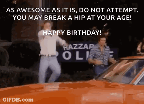 Two Men Are Dancing In Front Of An Orange Car With The Words `` As Awesome As It Is , Do Not Attempt . GIF