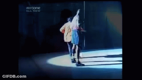 Two Men Are Dancing On A Stage In Front Of A Sign That Says Storyone GIF