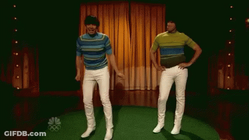Two Men Are Dancing On A Stage With The Nbc Logo In The Background . GIF