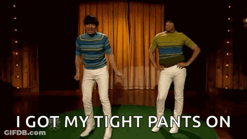 Two Men Are Dancing On A Stage With The Words `` I Got My Tight Pants On '' Behind Them . GIF