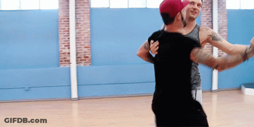 Two Men Are Dancing Together In A Dance Studio GIF