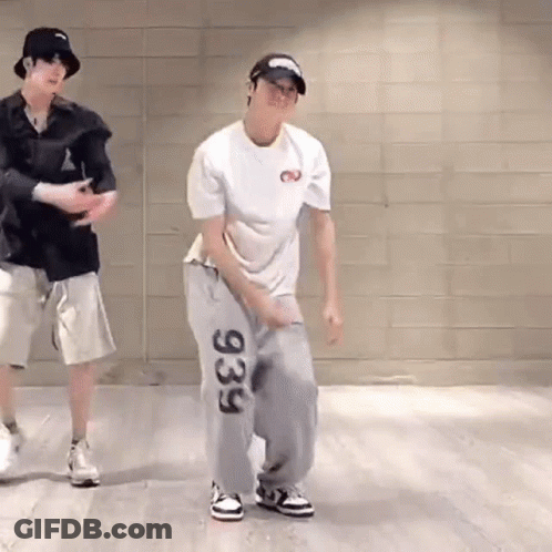 Two Men Are Dancing Together In A Room . GIF