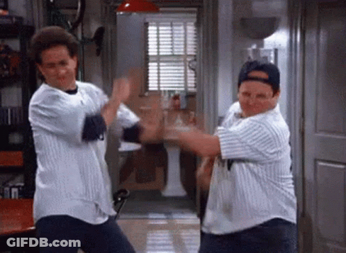 Two Men Are Dancing Together In A Room While Wearing Baseball Jerseys . GIF