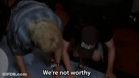 Two Men Are Dancing With Their Hands In The Air And One Of Them Is Saying We 'Re Not Worthy . GIF