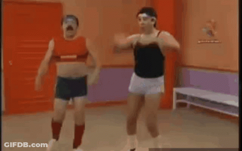 Two Men Are Doing Exercises In A Gym . GIF