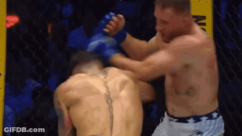Two Men Are Fighting In A Boxing Ring And One Of Them Has A Tattoo On His Back . GIF