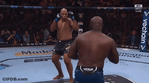 Two Men Are Fighting In A Boxing Ring And One Of Them Has Venum On His Shorts GIF
