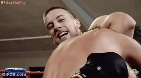 Two Men Are Fighting In A Boxing Ring And One Of Them Is Smiling GIF