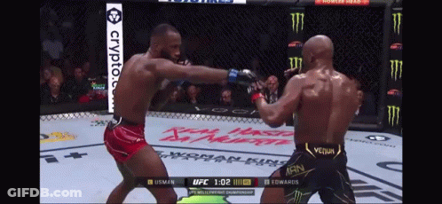 Two Men Are Fighting In A Boxing Ring And One Of Them Is Wearing A Venum Outfit GIF