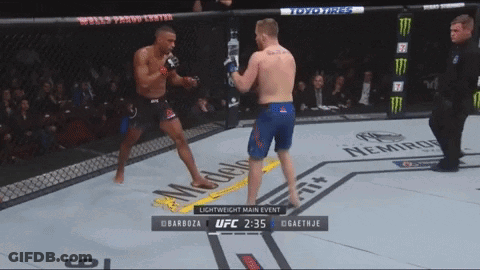 Two Men Are Fighting In A Boxing Ring And The Ufc Lightweight Main Event Is Shown On The Screen GIF