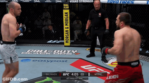 Two Men Are Fighting In A Boxing Ring Sponsored By Call Of Duty And Toyo Tires GIF