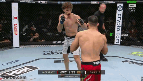 Two Men Are Fighting In A Boxing Ring With A Banner For Crypto.com GIF