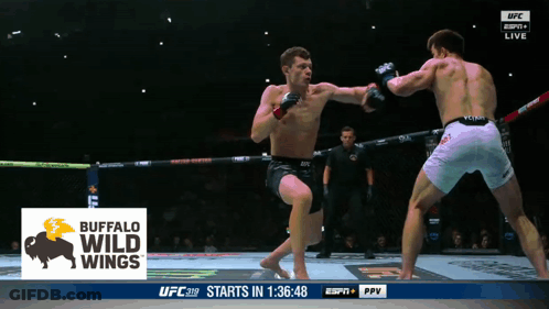 Two Men Are Fighting In A Boxing Ring With A Buffalo Wild Wings Logo On The Screen GIF