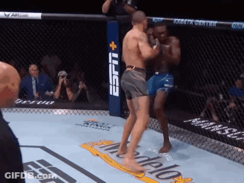 Two Men Are Fighting In A Boxing Ring With A Espn Logo In The Background GIF