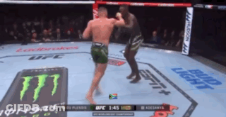 Two Men Are Fighting In A Boxing Ring With A Monster Energy Logo On The Floor GIF