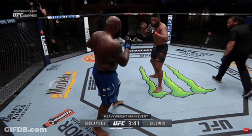 Two Men Are Fighting In A Boxing Ring With A Monster Logo On The Floor GIF