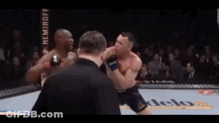 Two Men Are Fighting In A Boxing Ring With A Referee Watching GIF