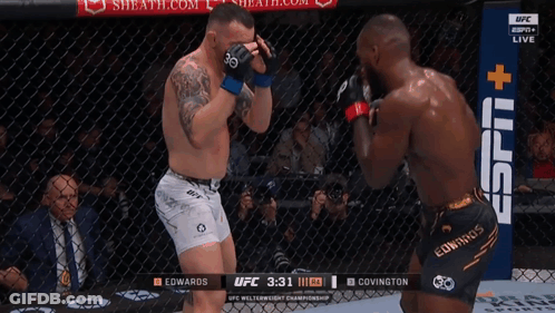 Two Men Are Fighting In A Boxing Ring With A Sign That Says Espn + GIF