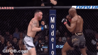 Two Men Are Fighting In A Boxing Ring With A Sign That Says Modelo GIF