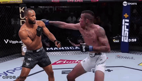 Two Men Are Fighting In A Boxing Ring With A Tnt Sports Sign In The Background GIF