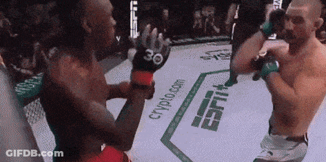 Two Men Are Fighting In A Boxing Ring With Espn Written On The Floor GIF