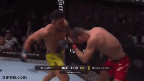 Two Men Are Fighting In A Boxing Ring With The UFC Logo In The Corner GIF