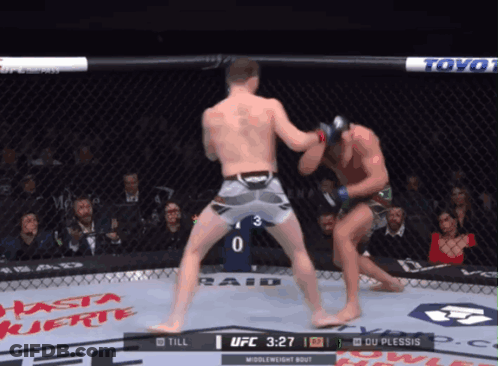 Two Men Are Fighting In A Boxing Ring With The Ufc Logo On The Corner GIF