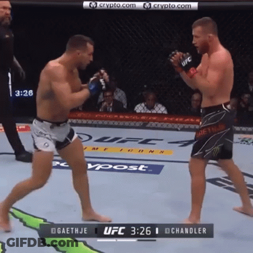 Two Men Are Fighting In A Boxing Ring With The Ufc Logo On The Wall GIF