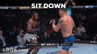 Two Men Are Fighting In A Boxing Ring With The Words Sit Down On The Bottom GIF