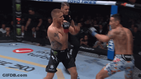 Two Men Are Fighting In A Boxing Ring With Toyo Tires On The Side GIF