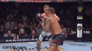 Two Men Are Fighting In A Cage With Utah Sports Commission Written On The Fence GIF